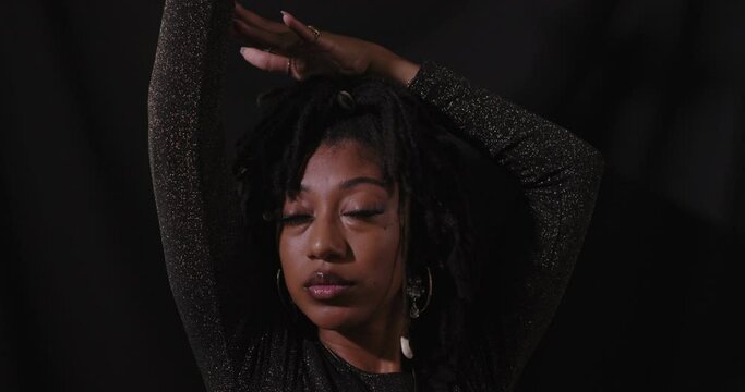 Portrait shot of young sensual African American women with black background