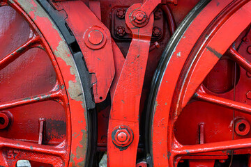 Two red wheels of an old steam locomotive with brake - 763175633