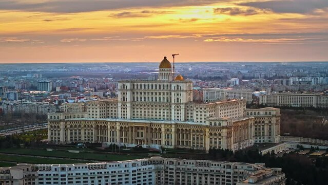 Aerial drone view of Palace of the Parliament in Bucharest downtown at sunset. Multiple districts around, Romania