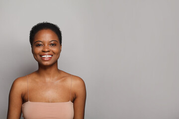 Joyful wellness model woman with dark shiny skin and cute smile close-up portrait. - 763179065
