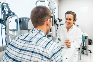 Man and ophthalmologist talking during a annual check up