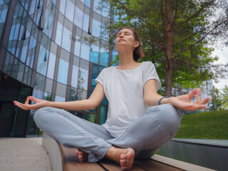 De-stress, unwind idea. peaceful female freelance employee practicing yoga exercises while sitting...