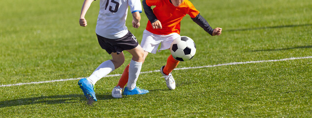 Boys Playing a Competitive Soccer Football Game. Young Players in Sports Duel. Kids Kicking the Ball During Junior Soccer League