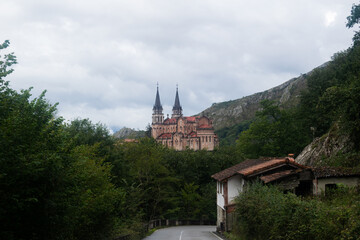 Mountain road with the Basilica of Covadonga in the background. Asturias - Spain