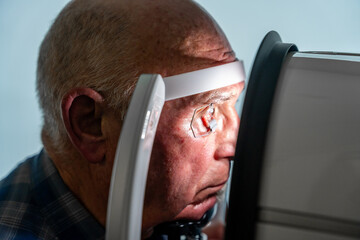 Man with eye opener during a laser treatment for glaucoma