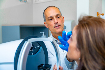 Ophthalmologist checking the woman's eye during treatment for glaucoma