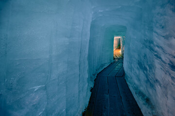 Spectacular blue ice tunnel for tourists inside of Rhone glacier. Unbelievable view of ice wall and...