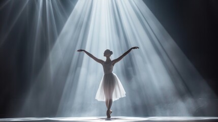 Ballerina standing on stage with gracefully outstretched arms