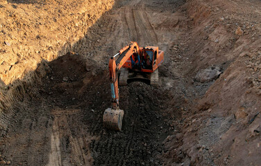 Excavator on earthmoving. Open pit mining. Backhoe dig ground in quarry. Heavy construction...