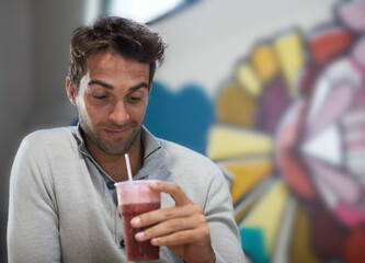 Happy, drink and smoothie for man with smile for healthy diet of strawberry, fruit and show of beverage. Male person, guy and adult relax with blended cocktail for energy, wellness and nutrition