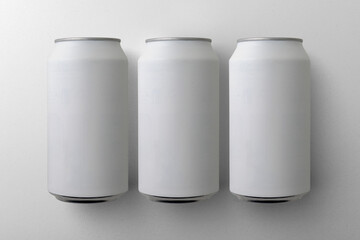 Three matte aluminium drink can mockups. (real photo) Beer, soda, pop, soft drink.