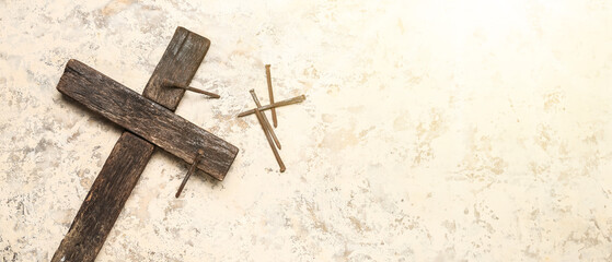 Wooden cross with nails on grunge background. Good Friday concept