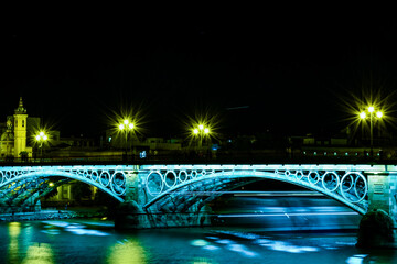 triana bridge illuminated at night