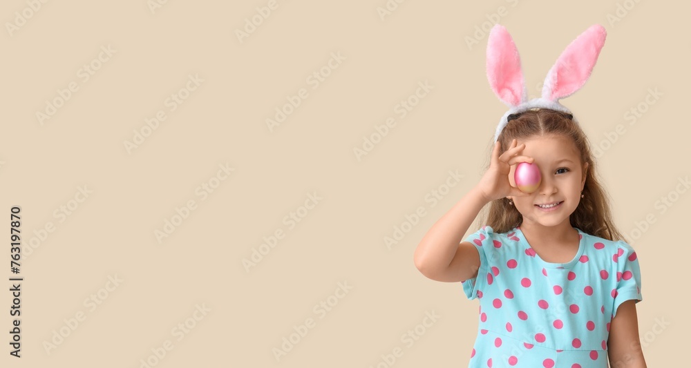 Poster cute little girl in bunny ears and with easter egg on light background with space for text