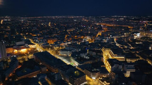 Aerial drone view of illuminated cityscape in the evening. Blue hour in Bucharest, Romania