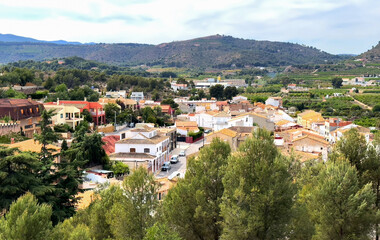 Fototapeta na wymiar Torres Torres town village, Valencia, Spain. Rural landscape. Buildings and houses in city. Town at mountain. Town at Mountains hills. Houses roofs in countryside. Olive farm field, Orange field