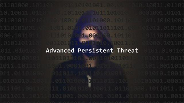 Advanced persistent threat cyber attack text in foreground screen, anonymous hacker hidden with hoodie in the blurred background. Vulnerability text in binary system code on editor program.