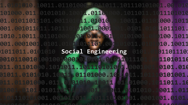 Social engineering cyber attack text in foreground screen, anonymous hacker hidden with hoodie in the blurred background. Vulnerability text in binary system code on editor program.
