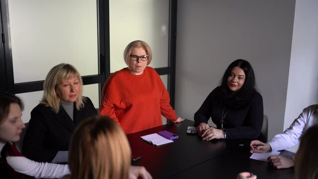  woman with a disability expresses her opinion at a meeting in the office