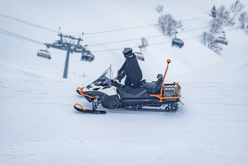 Man driving snowmobile on the ski resort. - 763210432