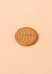 Maria biscuit on pink beige background. Trendy color of the year 2024 - Peach Fuzz.