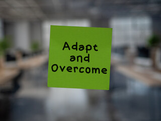 Post note on glass with 'Adapt and Overcome'.