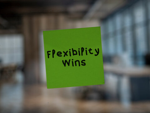 Post note on glass with 'Flexibility Wins'.