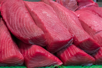 Pieces of freshly caught and chopped bluefin tuna for sale in the specialized fishmonger of a traditional market on the Spanish Atlantic coast.