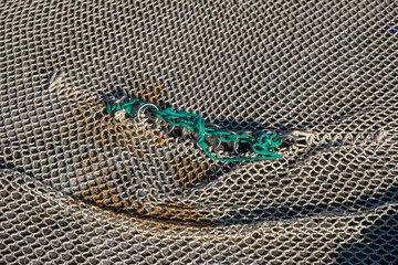 Detail of a patched industrial fishing net. Industrial fishing.