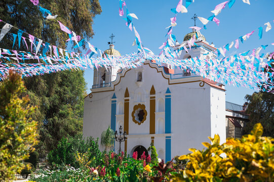 Atrio de la Iglesia - beautiful church with flowers and bunting in Spring by El Tule, Santa Maria Del Tule, Oaxaca, Mexico