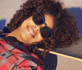 Black woman, outdoor and smile with sunglasses on skateboard for training and relax in Atlanta . Closeup, female person and skater with hobby or sport for fitness, health and fun at skatepark © Mariusz S/peopleimages.com