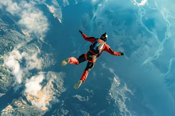 Deurstickers A skydiver soars through the sky, circling at high altitude in a free-fall attitude © VetalStock