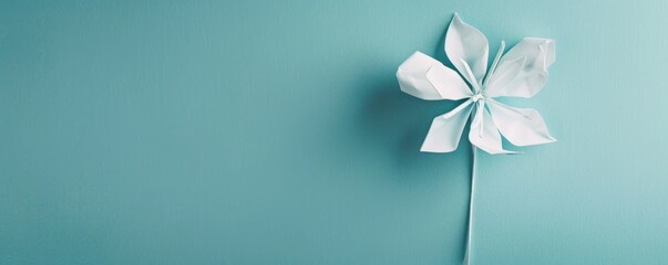 Simple paper pinwheel on blue background - obrazy, fototapety, plakaty