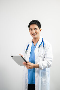 Man portrait of a doctor wearing a white coat and a stethoscope looking into the camera on a white isolated background