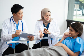 Hospital Ward Male and  Male Professional Asian Doctors Talk with a Patient, Give Health Care...