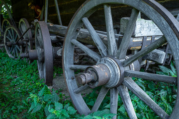 Old wooden wagon wheels in the countryside, close-up view.