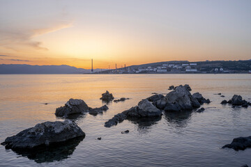 Panoramic sunset in Rijeka with refinery in foreground and city in background. Croatia.