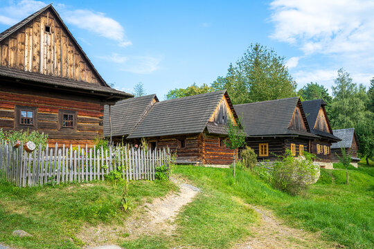 Old wooden wallachia houses in old village with green meadow. Roznov pod Radhostem. Czech Republic.