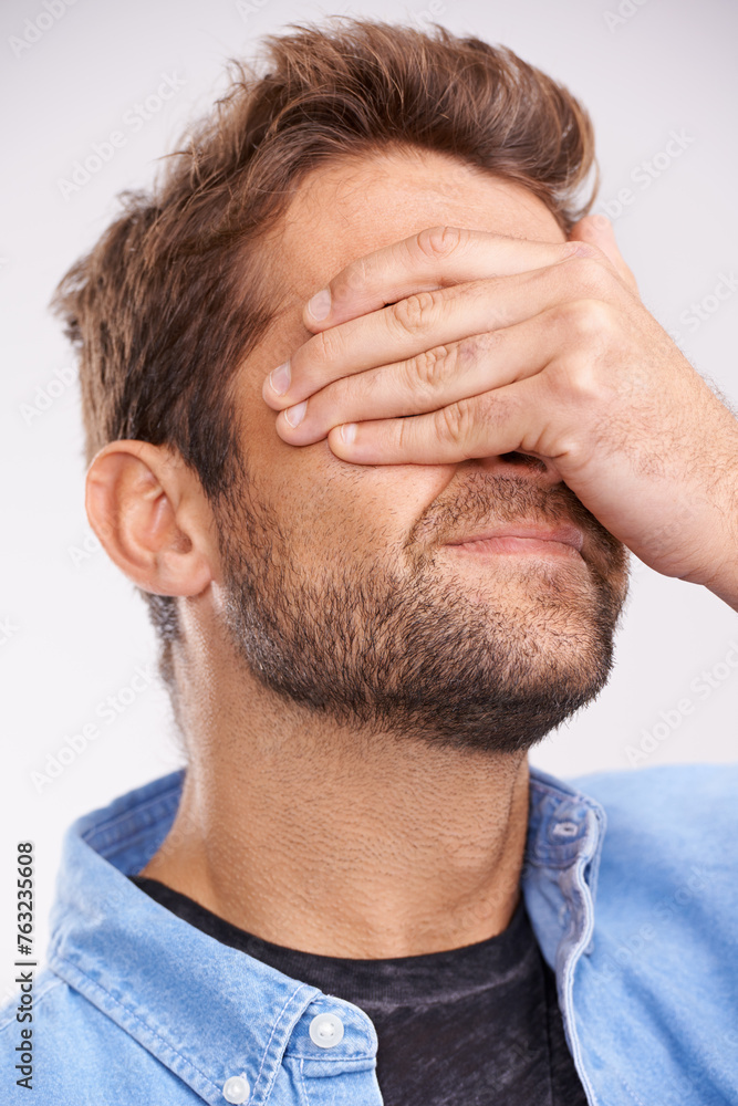 Poster man, face palm and mistake with thinking, regret or anxiety on a grey studio background. person, fai