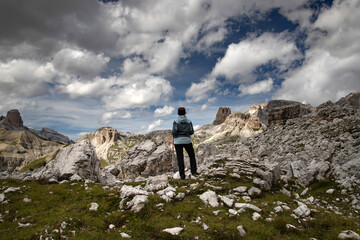 Stunning view of a tourist enjoying the view in the Tre Cime Di Lavaredo National park, Dolomites, Italy.