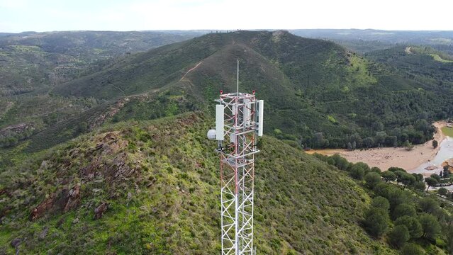 Aerial drone view of GSM, 4G, 5G and radio telecommunication towers on the top of a mountain. Cell phone tower and transceiver station. Antenna transmitter for wireless communication