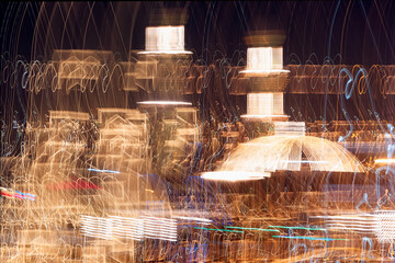 Abstract background of moving shot of lights of a mosque silhouette