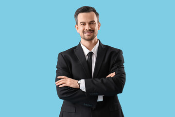 Portrait of male real estate agent on blue background
