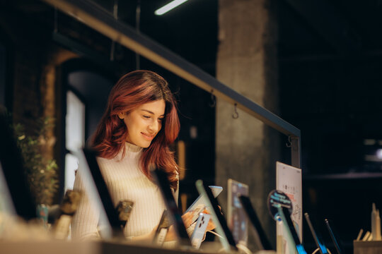 a woman buys a phone in an electronics store