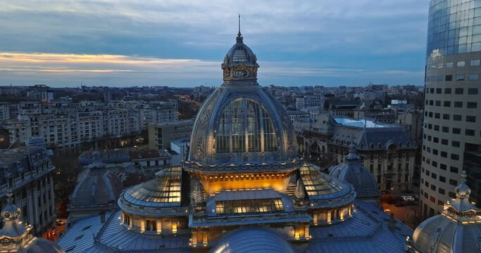 Aerial drone view of the illuminated dome of Palace of the Deposits and Consignments in the evening. Blue hour in Bucharest, Romania
