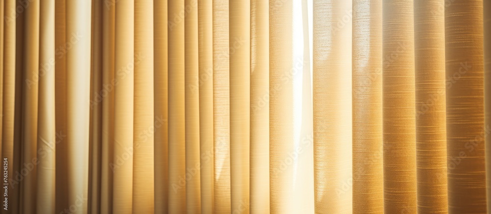 Poster A close up of a golden curtain against a blurred background, showcasing shades of amber and peach. The intricate pattern complements the wood and metal accents in the room