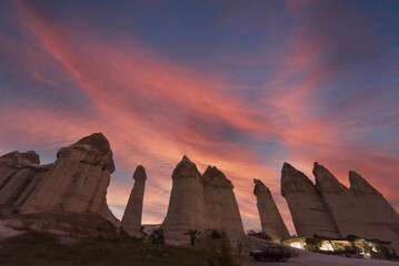Cappadocia region fairy chimneys with northern lights and sunset clouds and colors