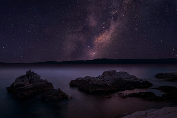Milky way over the sea at night. Long exposure photograph.