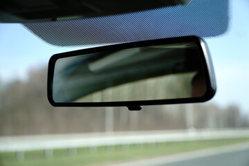 Car rear view mirror and defocused background