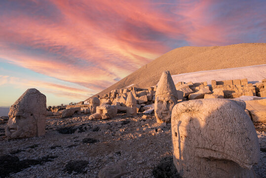 nemrut mountain statues of gods with sunset clouds on sky and colors